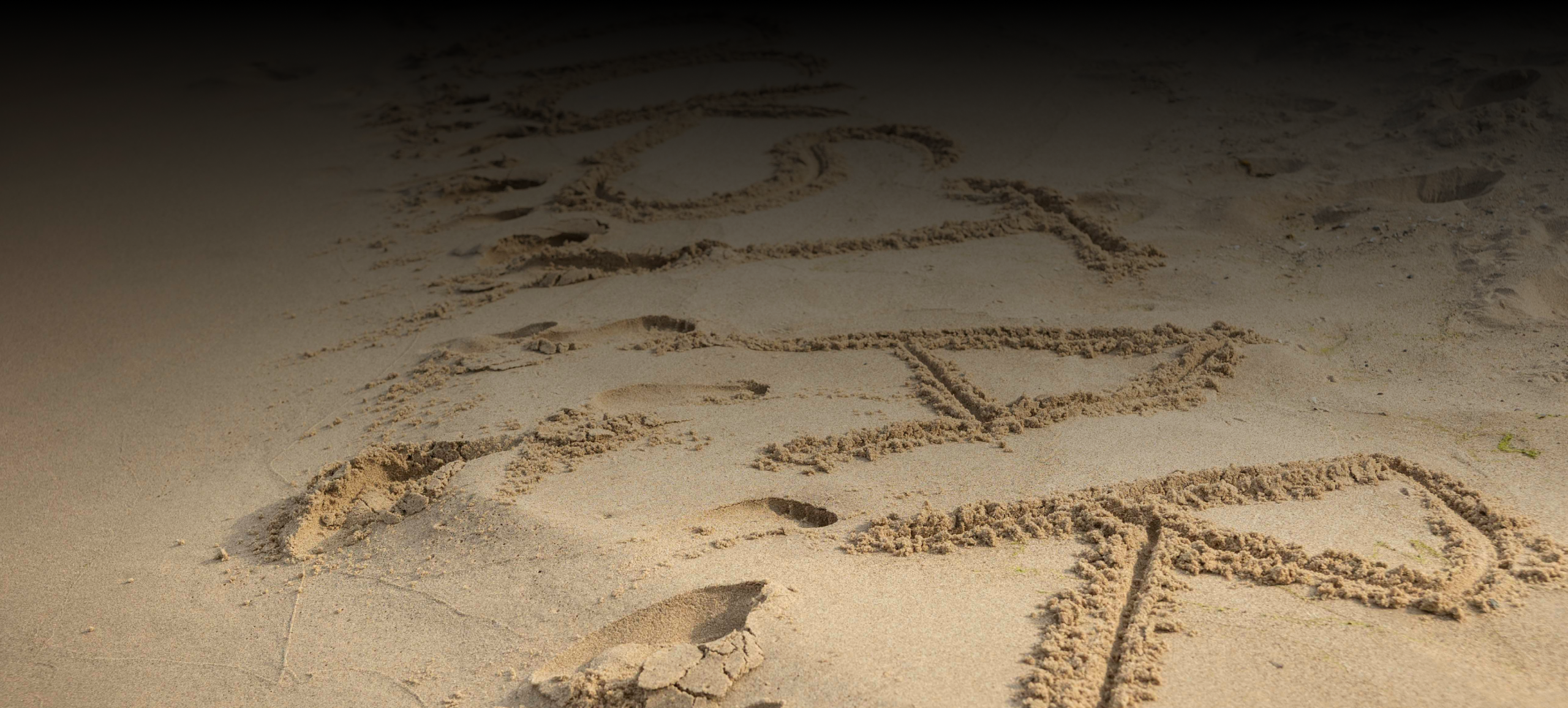 Rockstar written in the sand of a beach